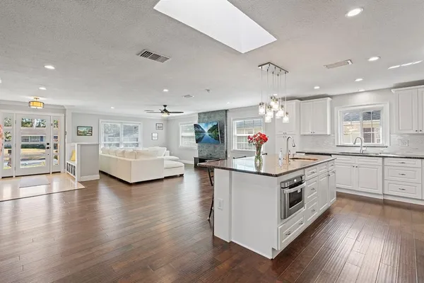 a kitchen with stove a sink and a refrigerator
