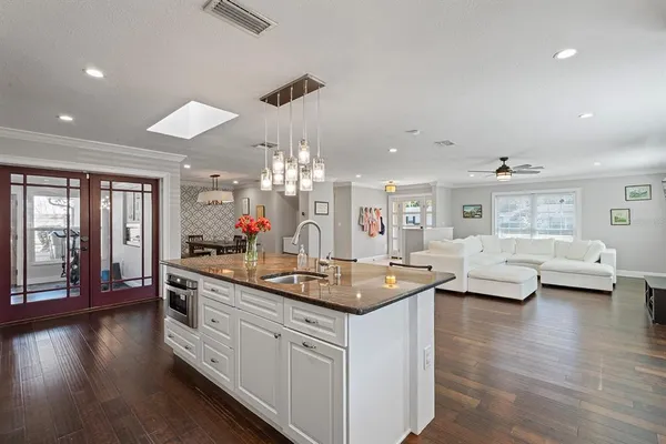 a kitchen with counter top space and wooden floor