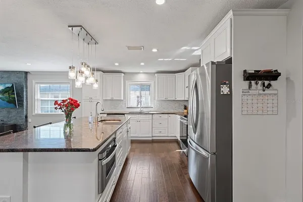 a kitchen with a refrigerator a sink and dishwasher