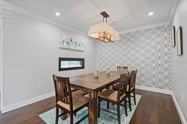 a view of a dining room with furniture wooden floor and a chandelier