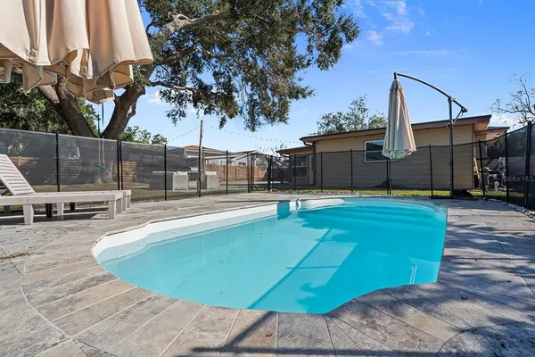 a view of a swimming pool with a patio