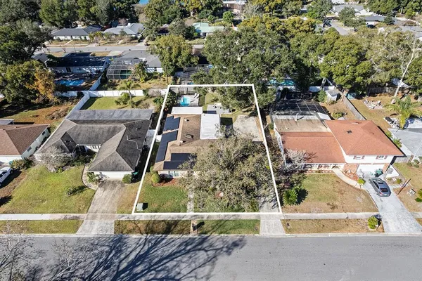 an aerial view of residential houses with outdoor space