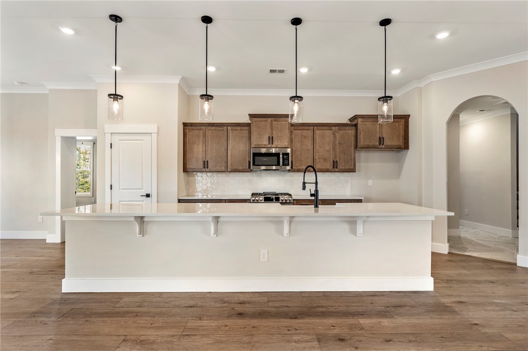 103 Wagner Court Easley, SC 29642 - Photo 10 of 36 This modern kitchen features a spacious island, sleek countertops, and ample cabinetry for effortless living.