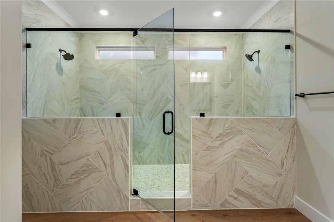 103 Wagner Court Easley, SC 29642 - Photo 19 of 36 This spacious bathroom features a walk-in shower with elegant tile work and dual shower heads.