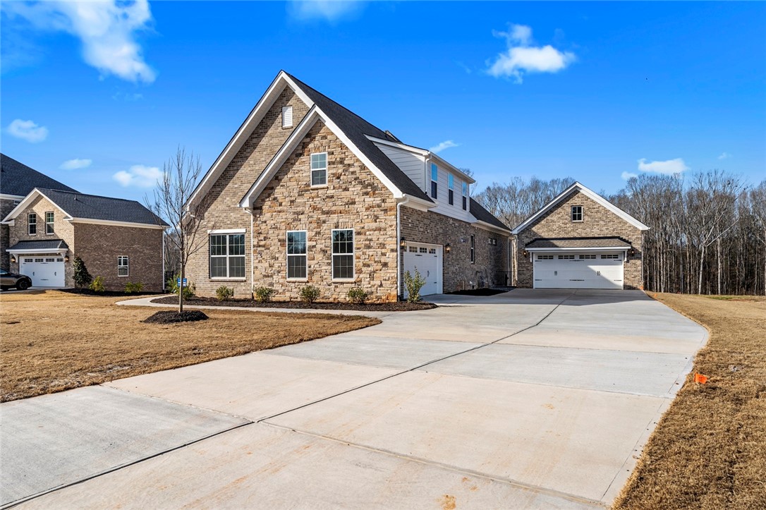 103 Wagner Court Easley, SC 29642 - Photo 2 of 36 This spacious property boasts a grand facade with multiple garages and an inviting entryway.