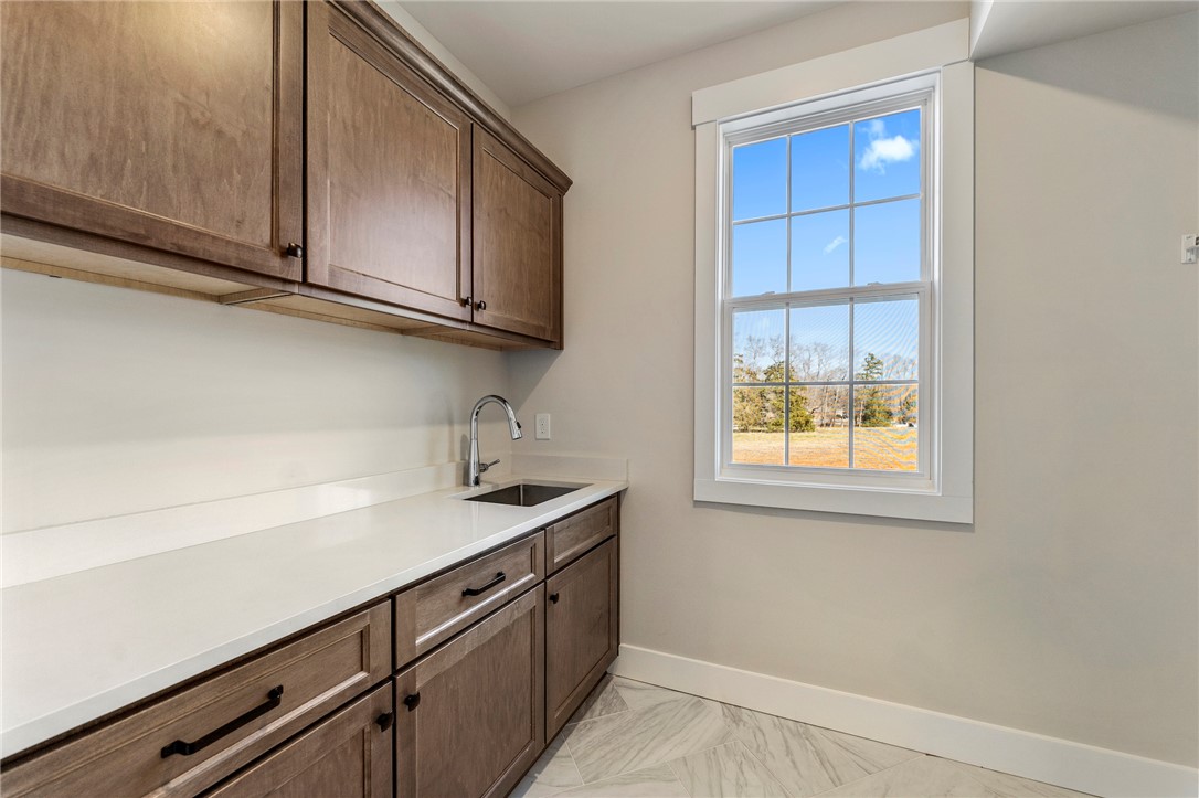 103 Wagner Court Easley, SC 29642 - Photo 23 of 36 This spacious laundry room offers ample storage, a functional sink, and a view of the outdoors.