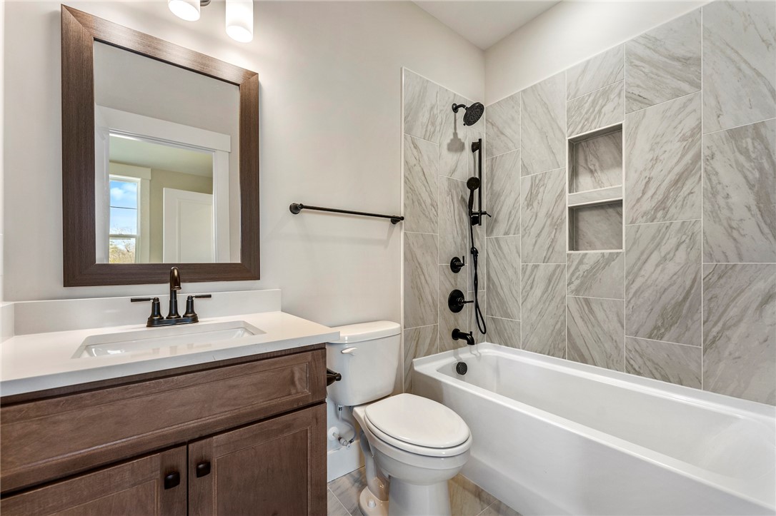 103 Wagner Court Easley, SC 29642 - Photo 31 of 36 This bathroom features a sleek vanity, a bathtub, and stylish tiled walls.