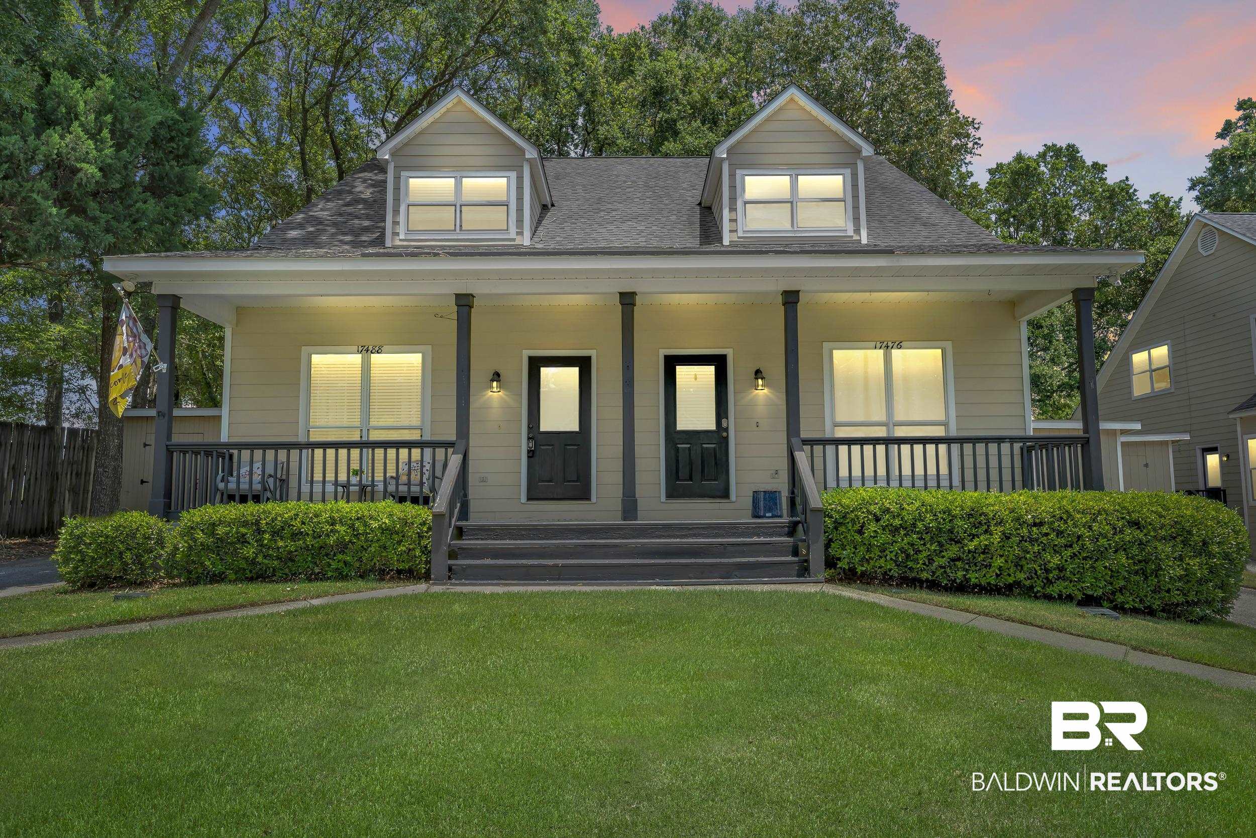 17488 Pandion Ridge, Unit A1 Fairhope, AL 36532 - Photo 1 of 18 Duplex property featuring a covered front porch with dark railings and support columns