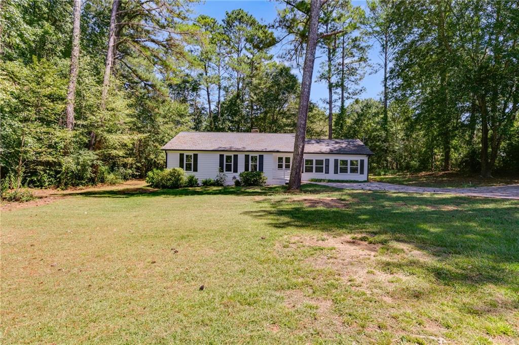 413 Roy North Road Carrollton, GA 30117 - Photo 1 of 1 a front view of a house with swimming pool
