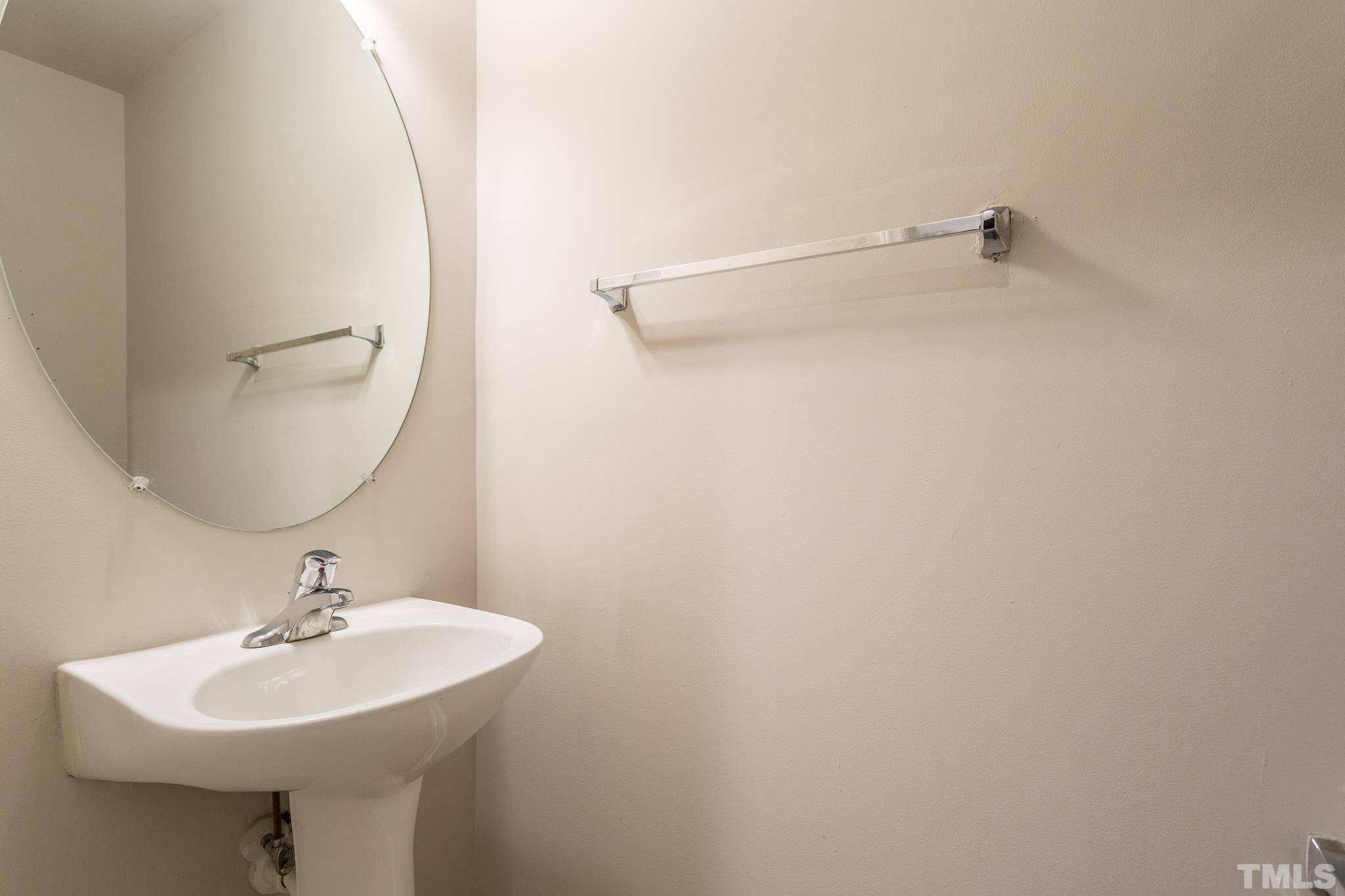 1004 Lombar Street Raleigh, NC 27610 - Photo 17 of 34 a bathroom with a sink a mirror and a shower