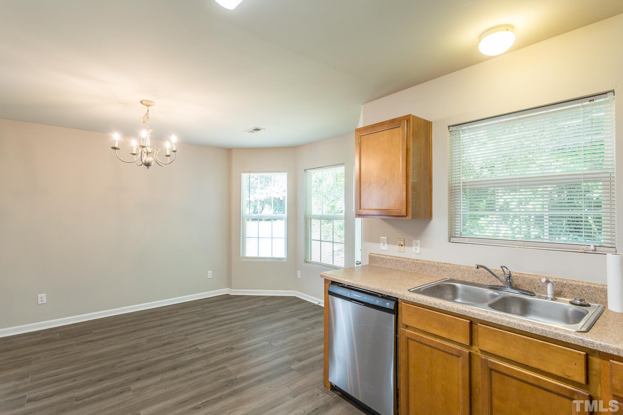 1004 Lombar Street Raleigh, NC 27610 - Photo 19 of 34 a kitchen with a sink cabinets and window