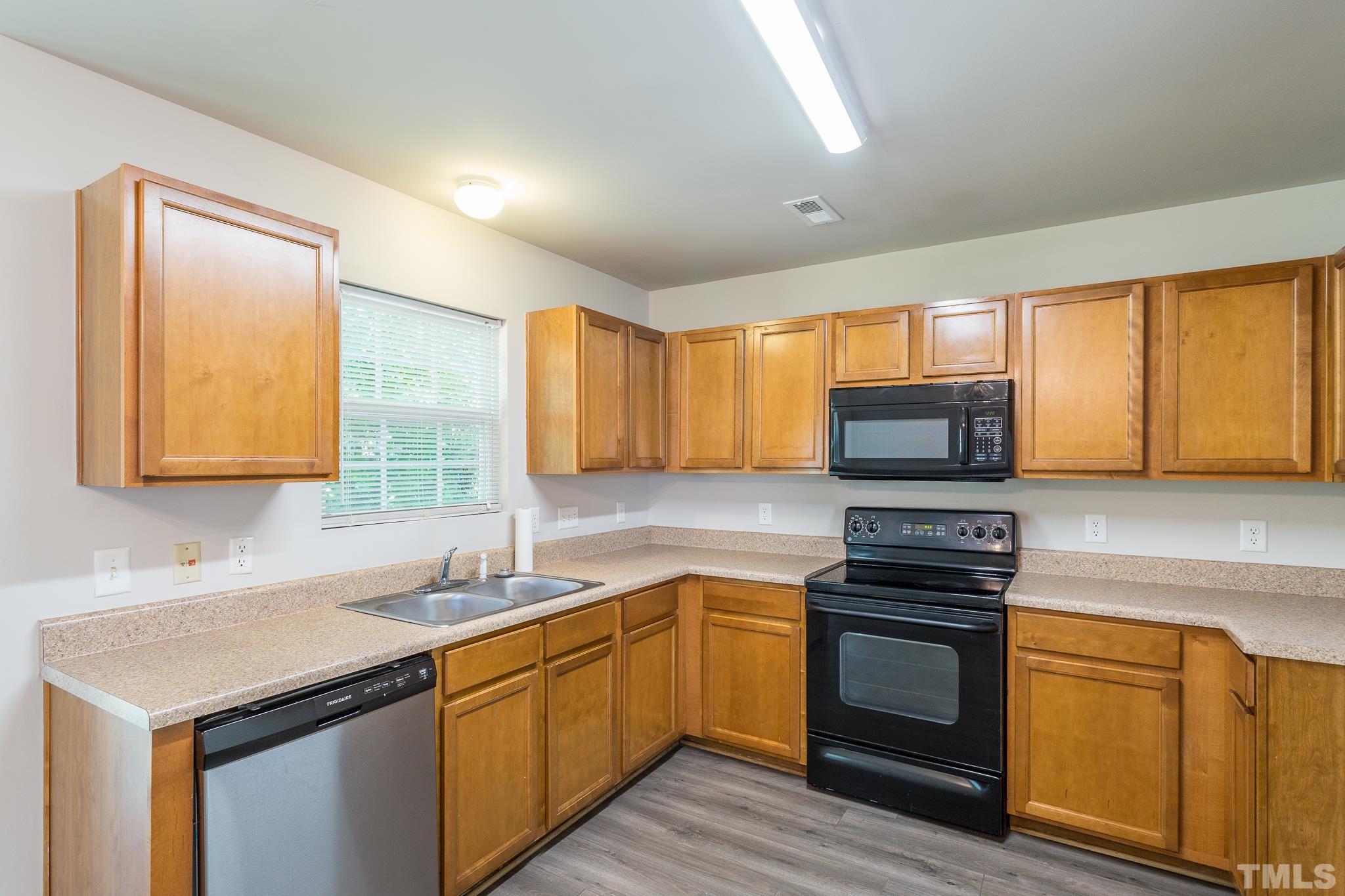 1004 Lombar Street Raleigh, NC 27610 - Photo 20 of 34 a kitchen with a sink stove and microwave