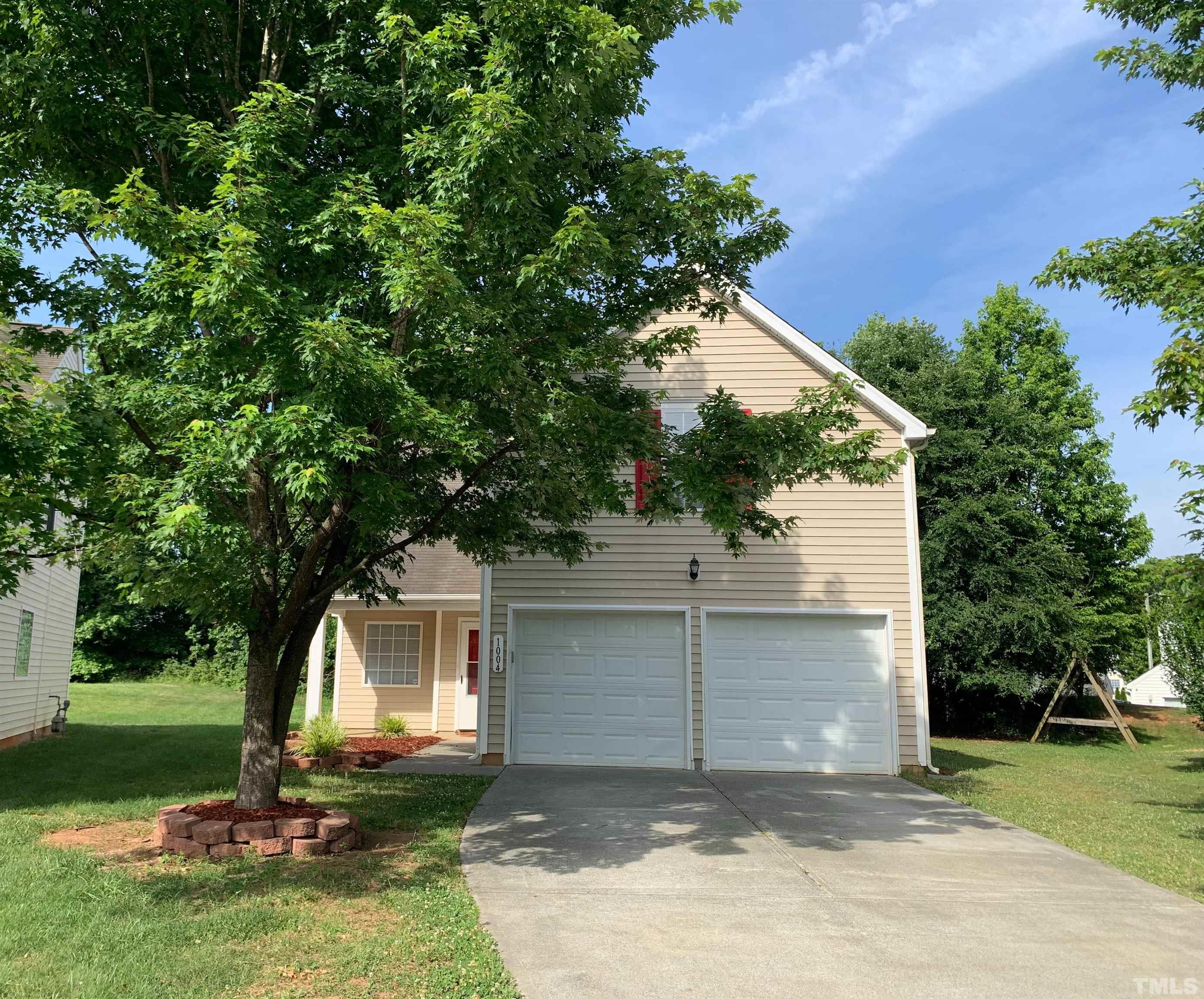 1004 Lombar Street Raleigh, NC 27610 - Photo 2 of 34 a front view of a house with a yard and tree