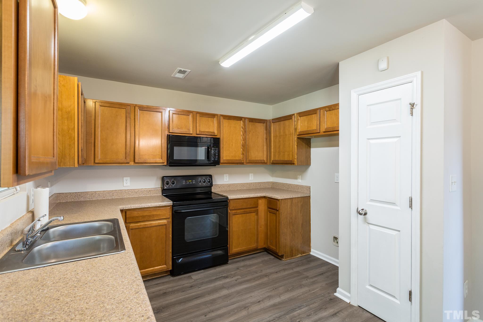 1004 Lombar Street Raleigh, NC 27610 - Photo 21 of 34 a kitchen with stainless steel appliances granite countertop a sink a stove and a refrigerator