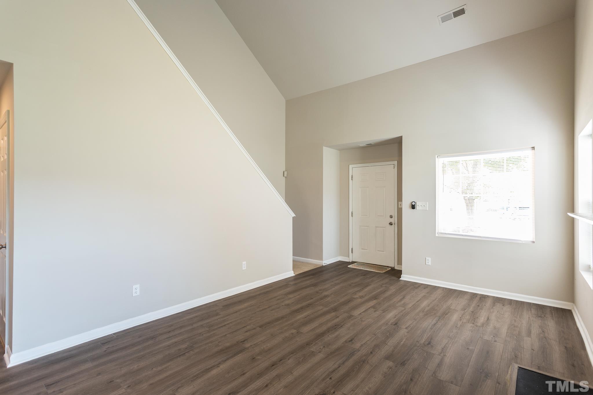 1004 Lombar Street Raleigh, NC 27610 - Photo 24 of 34 an empty room with wooden floor and windows