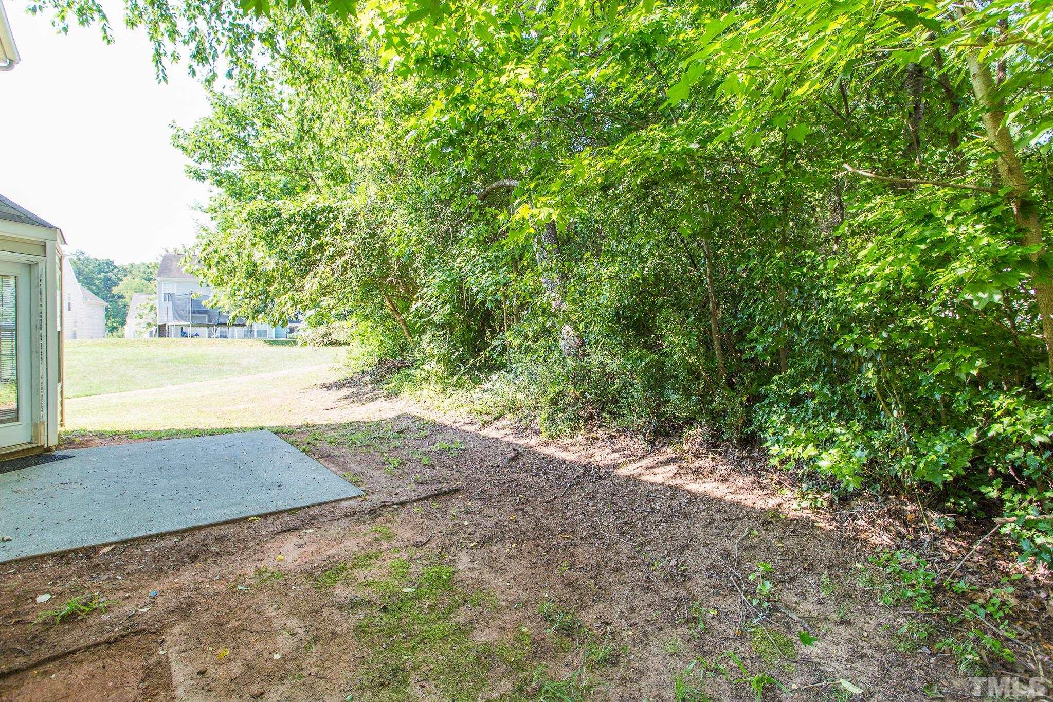 1004 Lombar Street Raleigh, NC 27610 - Photo 27 of 34 a view of a yard with large trees