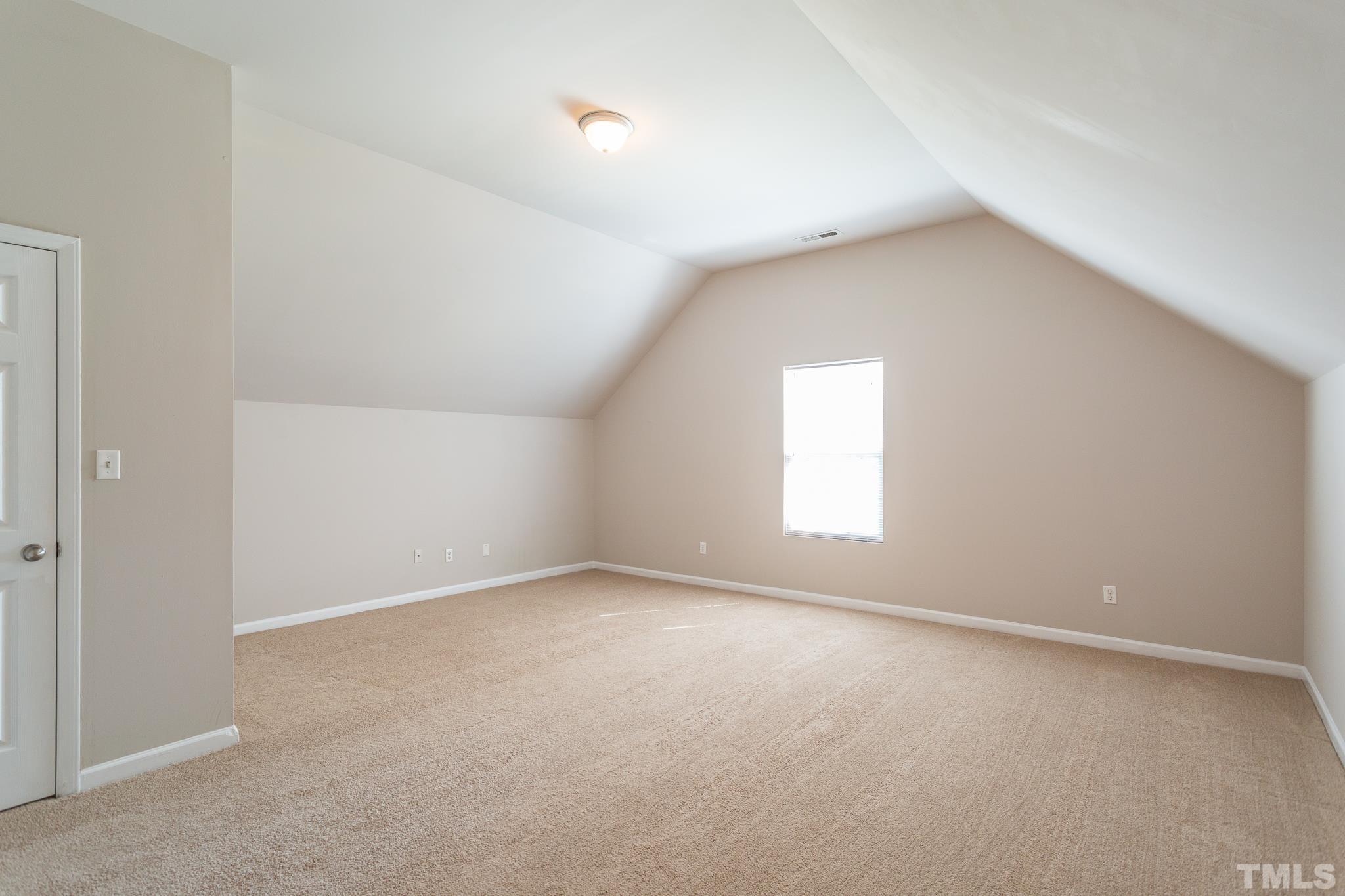 1004 Lombar Street Raleigh, NC 27610 - Photo 6 of 34 an empty room with a window and a ceiling fan