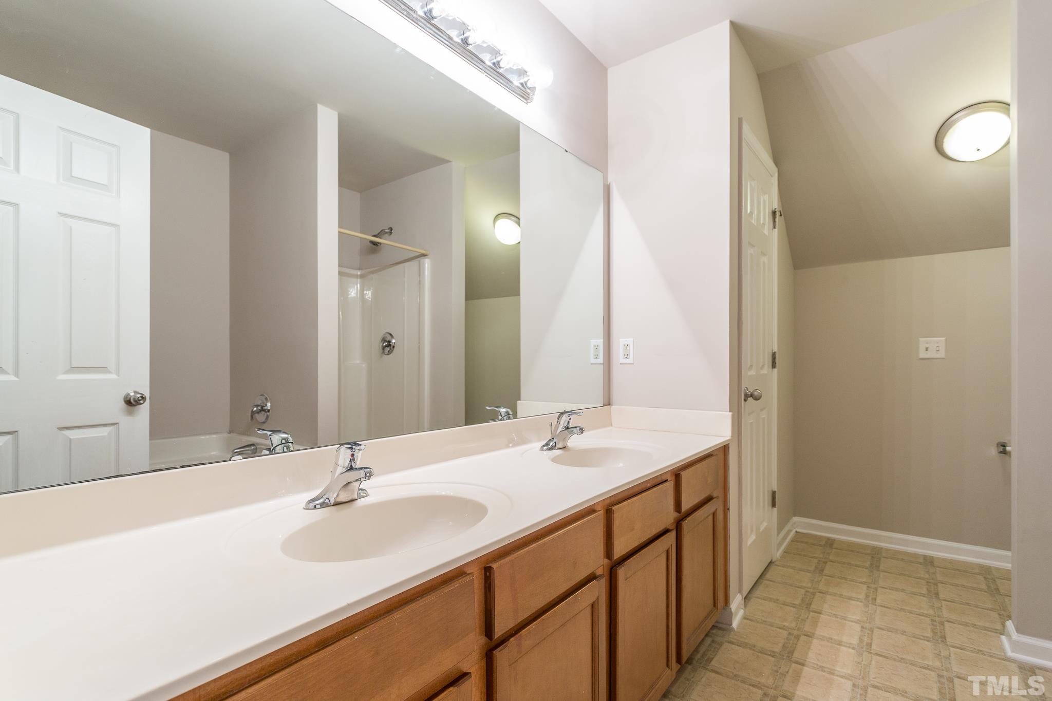 1004 Lombar Street Raleigh, NC 27610 - Photo 8 of 34 a bathroom with a sink and a mirror