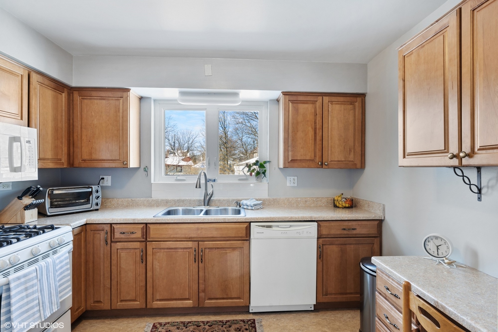 356 Herrick Road Riverside, IL 60546 - Photo 12 of 26 a kitchen with stainless steel appliances granite countertop a sink stove and cabinets