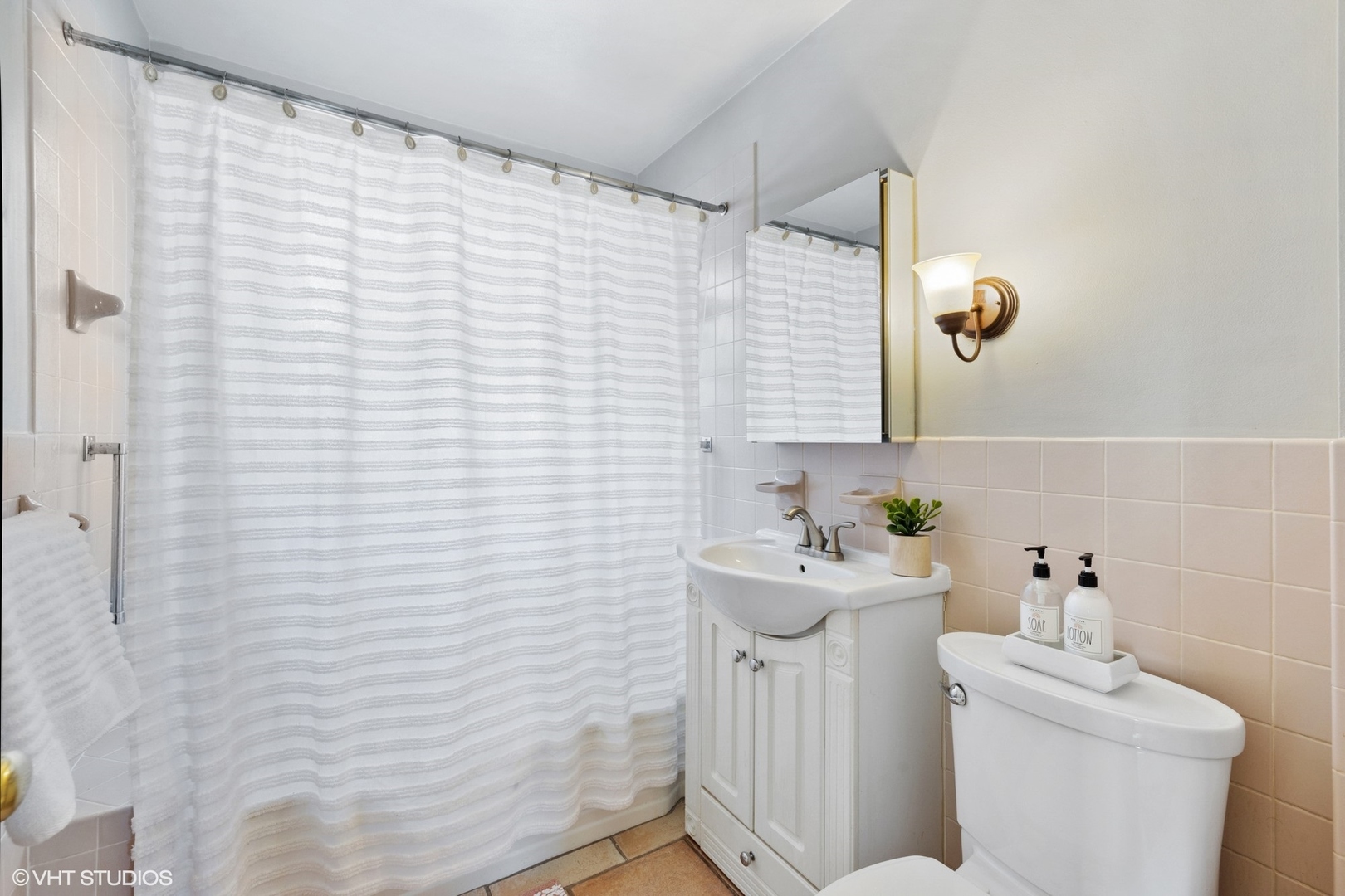 356 Herrick Road Riverside, IL 60546 - Photo 16 of 26 a bathroom with a sink a toilet and shower curtain