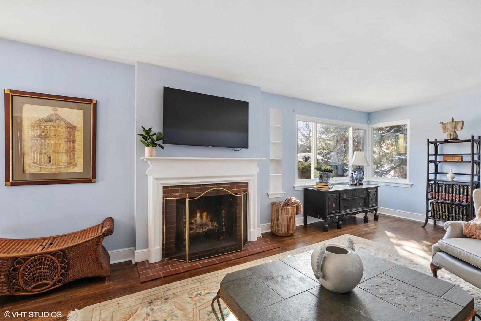 356 Herrick Road Riverside, IL 60546 - Photo 5 of 26 a living room with furniture a fireplace and a flat screen tv