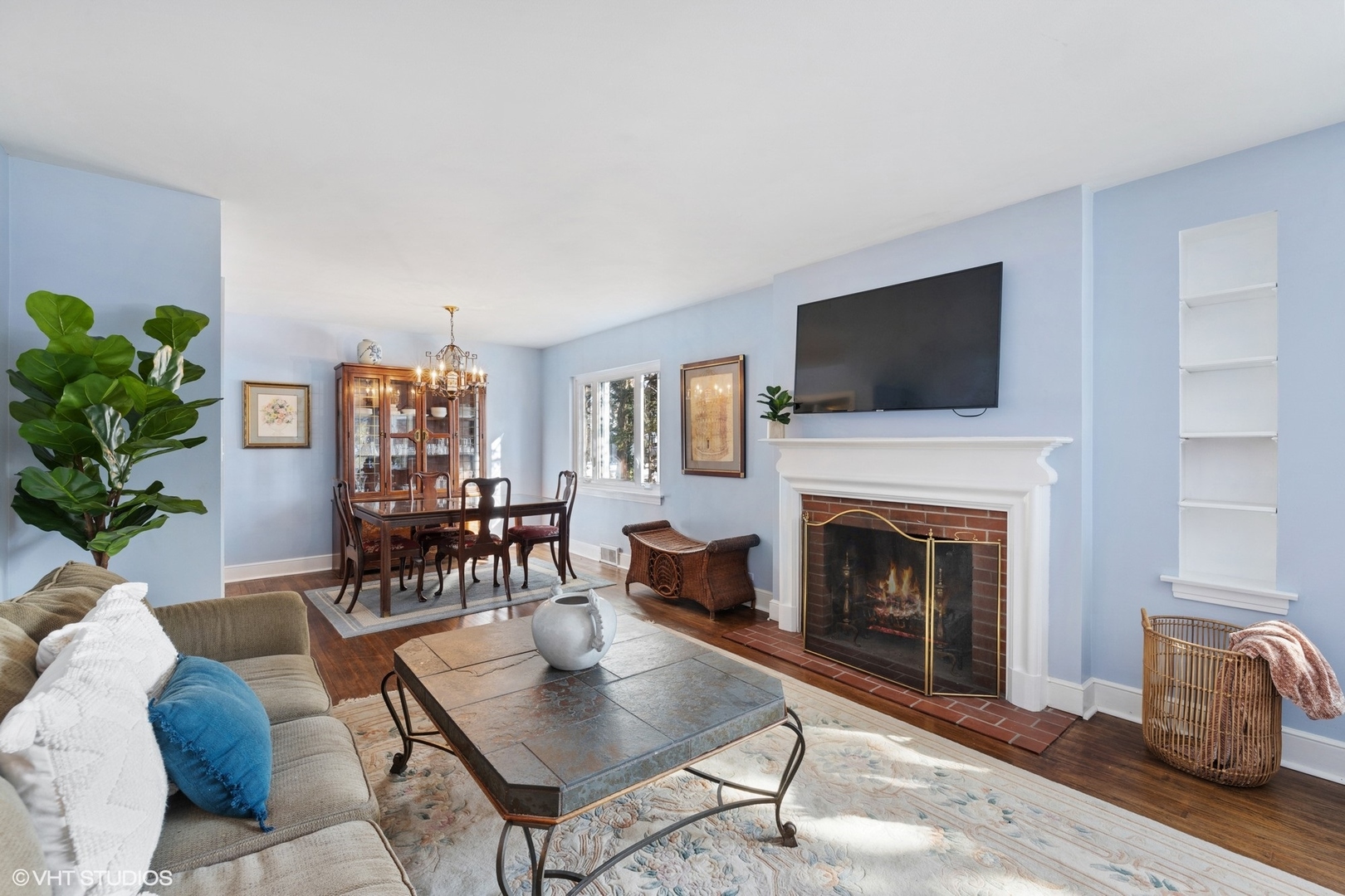 356 Herrick Road Riverside, IL 60546 - Photo 6 of 26 a living room with furniture a flat screen tv and a fireplace