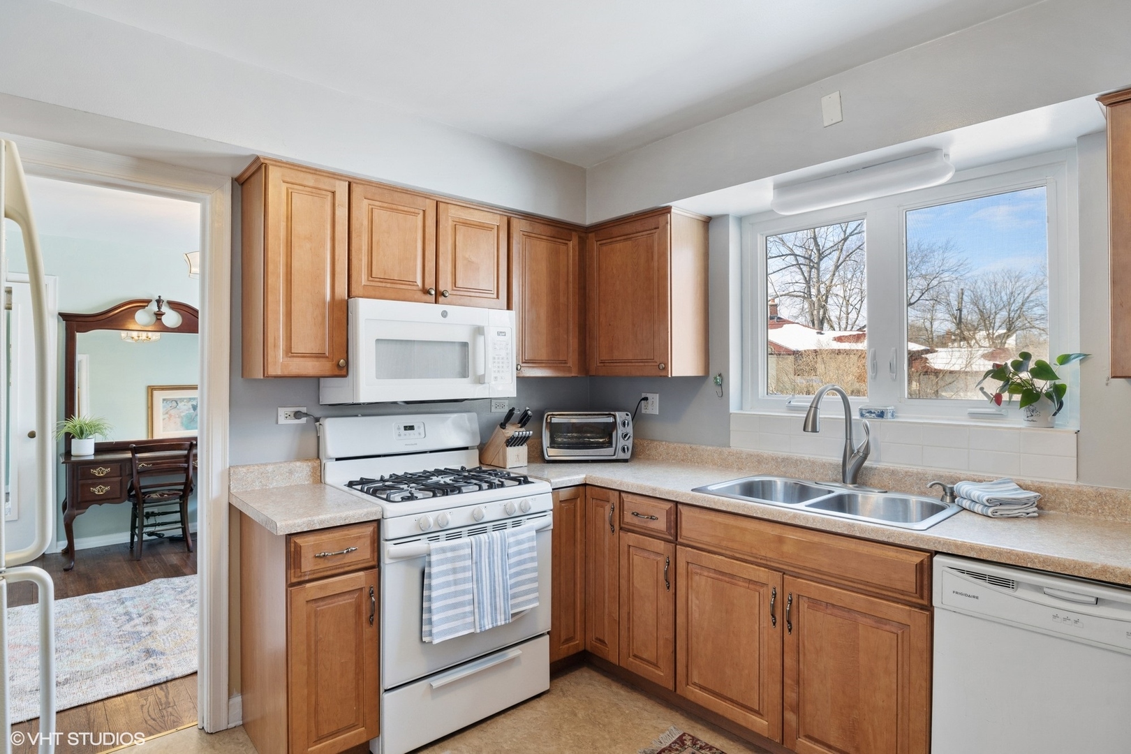 356 Herrick Road Riverside, IL 60546 - Photo 10 of 26 a kitchen with granite countertop white cabinets and white appliances