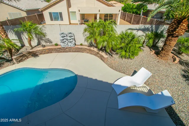 a view of a backyard with plants and a patio