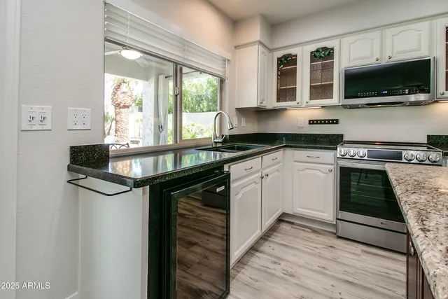 a kitchen with stainless steel appliances granite countertop a stove and a microwave