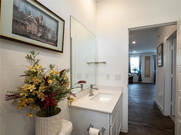 a bathroom with a sink mirror and vanity