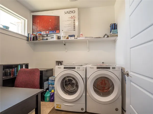 a utility room with sink dryer and washer