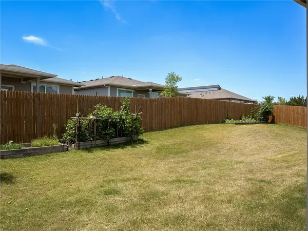 a view of a house with a backyard and balcony