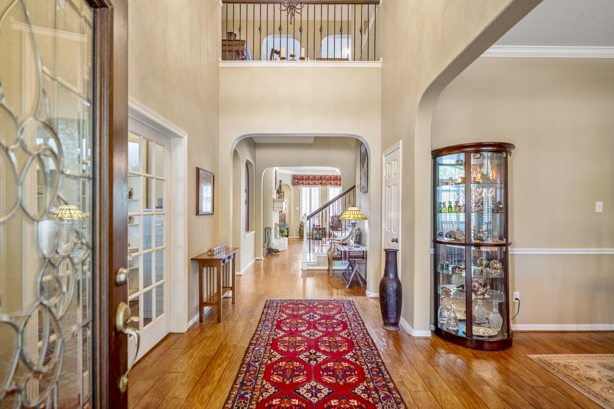 1438 Hatchmere Place Spring, TX 77379 - Photo 5 of 50 A light filled entry offers a large foyer with balcony featuring ornate iron railings, formal dining and study, arched doorway to the living area of the home.