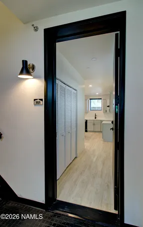 a view of a hallway with wooden floor