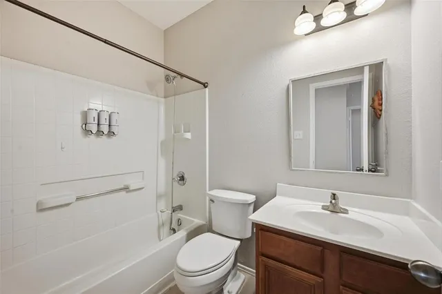 a bathroom with a granite countertop sink toilet a mirror and shower