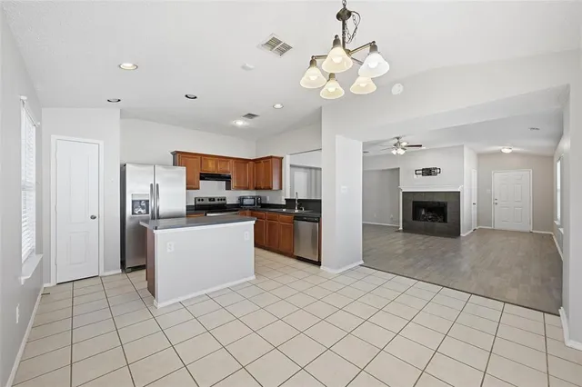 a large white kitchen with cabinets