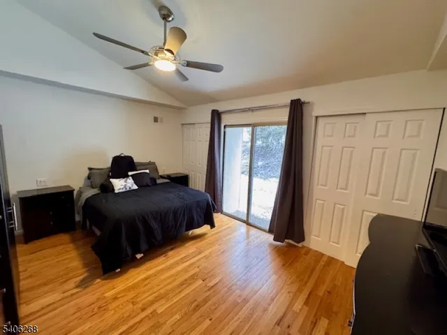 a bedroom with a bed window and a ceiling fan