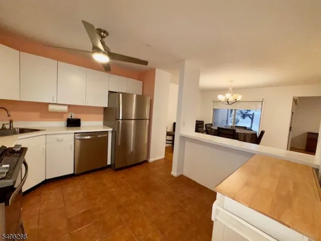a kitchen with a refrigerator sink and cabinets