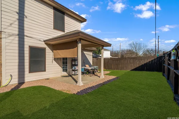 a view of a backyard with sitting area