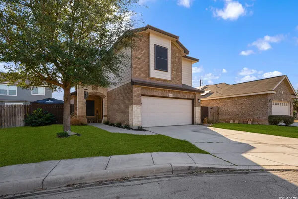 a front view of a house with a yard and a garage