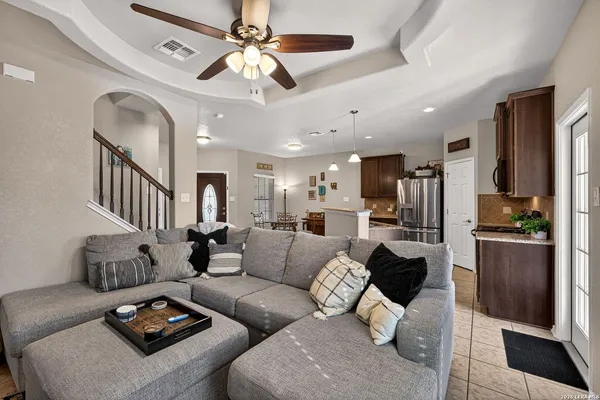a living room with furniture and a chandelier