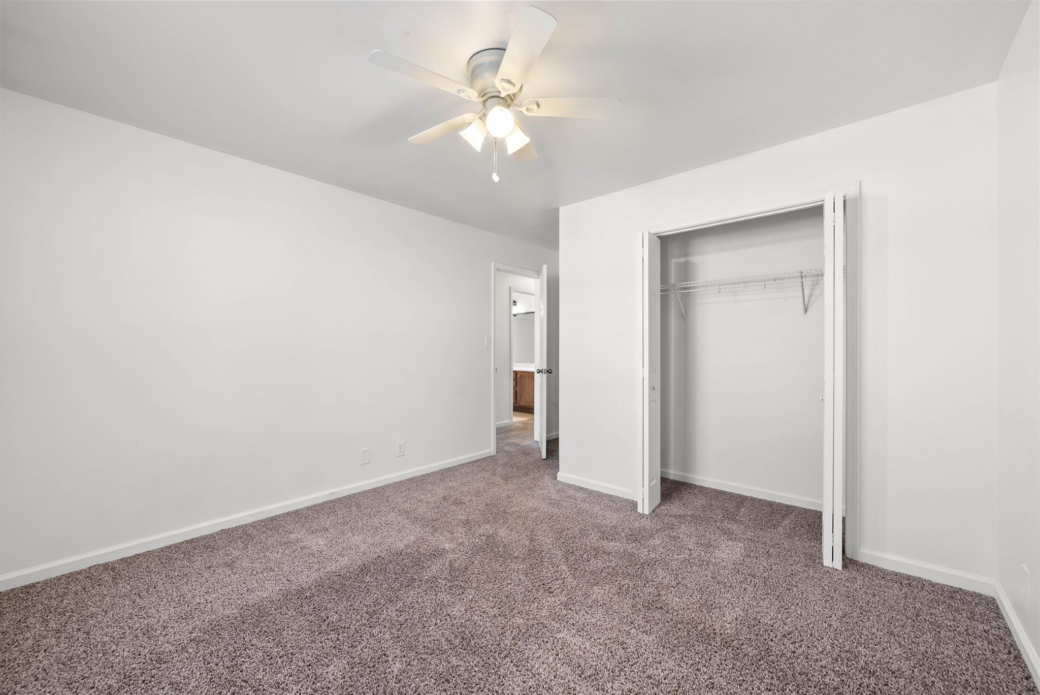 535 Lafayette Road, Unit F Clarksville, TN 37042 - Photo 19 of 26 an empty room with a chandelier fan and closet