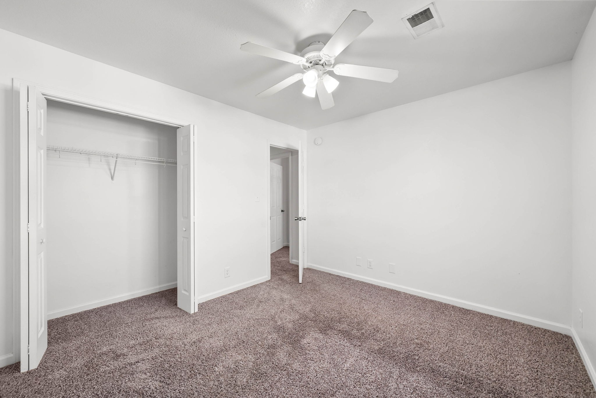535 Lafayette Road, Unit F Clarksville, TN 37042 - Photo 21 of 26 an empty room with a chandelier fan and closet