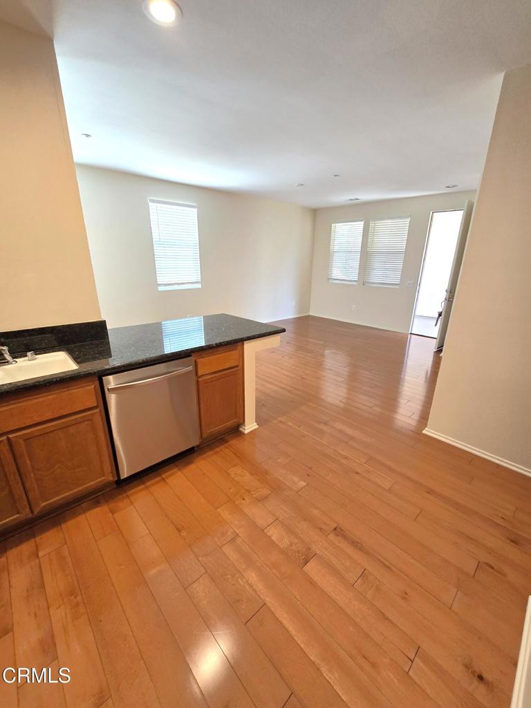 3319 North Ventura Road Oxnard, CA 93036 - Photo 6 of 25 a view of an empty room with wooden floor and a window