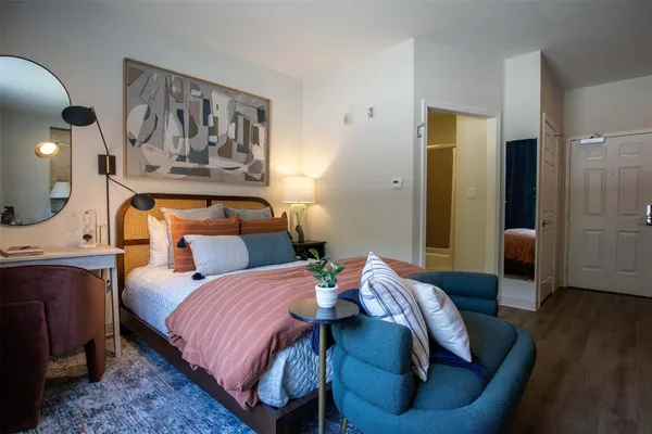 a bedroom with bed and wooden floor