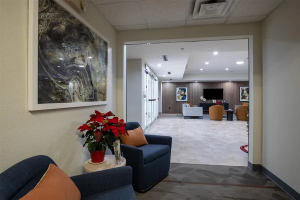 a living room with furniture and flowers