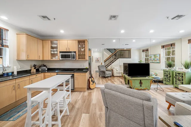 a living room with furniture a fireplace and a flat screen tv