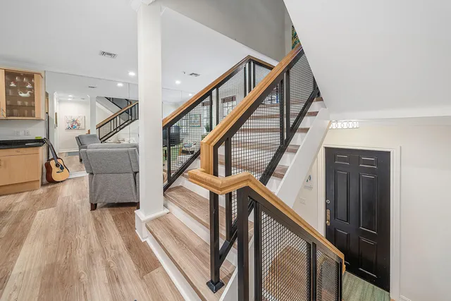 a view of entryway and hall with wooden floor