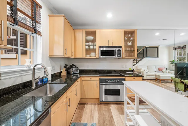 a kitchen with stainless steel appliances a stove sink microwave and cabinets
