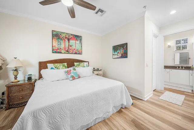 a bedroom with a bed and a painting on the wall